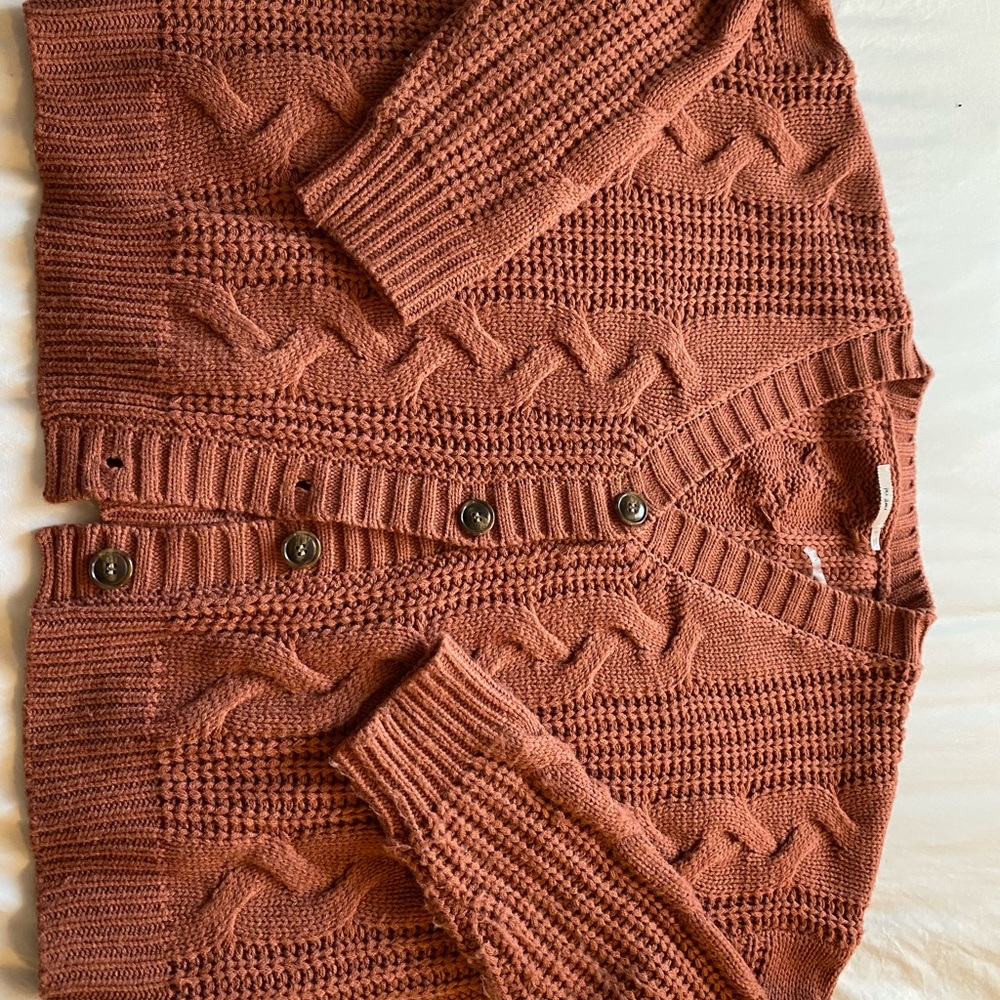 Francesca’s button up cardigan sweater in rust. Size small.